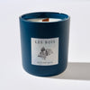 Blue candle with 'Les Bois Botanique' label on a white background