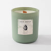 Green candle with 'Les Bois Esprit' label on a white background