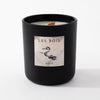 Black candle jar with 'Les Bois' label on a white background