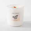 White candle with 'Les Bois Lumiere' label featuring a butterfly on a white background
