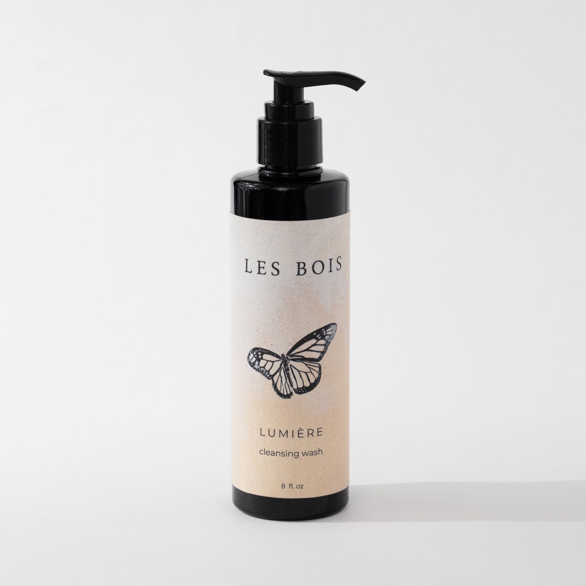 Bottle of Les Bois Lumérie castile wash with a butterfly design on a white background