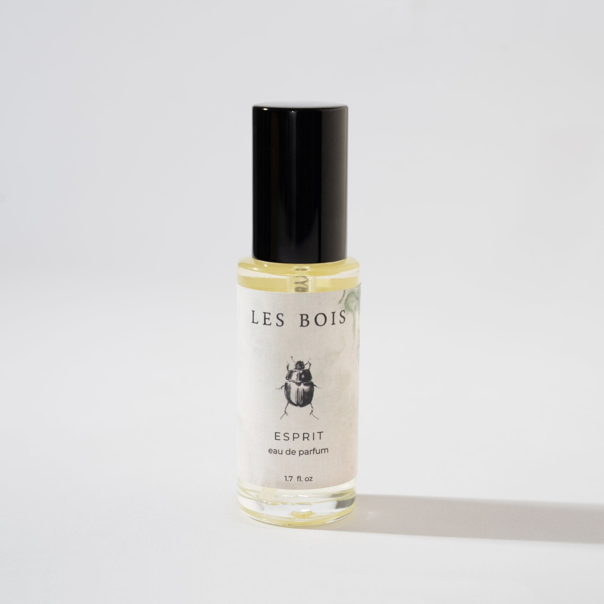 Perfume bottle labeled 'Les Bois' on a light gray background
