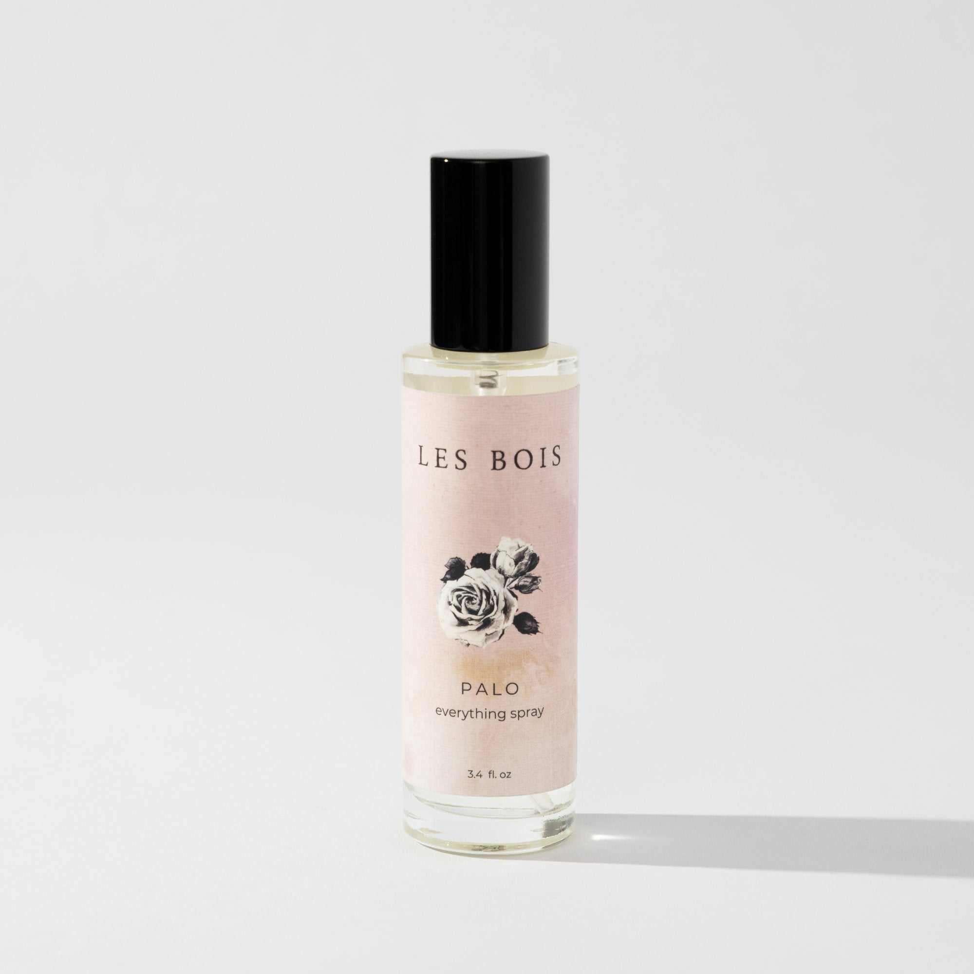Perfume bottle labeled 'Les Bois' on a light gray background