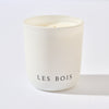 White candle in a container with 'LES BOIS' branding on a light gray background